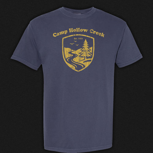 Camp Hollow Creek Emblem Tee. Navy blue comfort colors shirt with gold emblem.