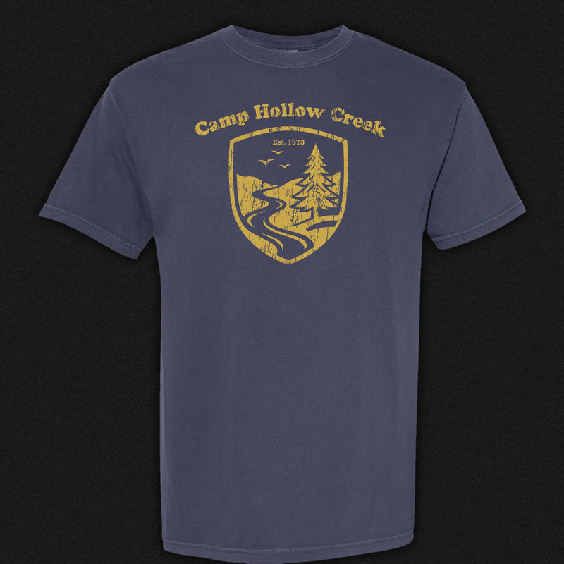 Camp Hollow Creek Emblem Tee. Navy blue comfort colors shirt with gold emblem.