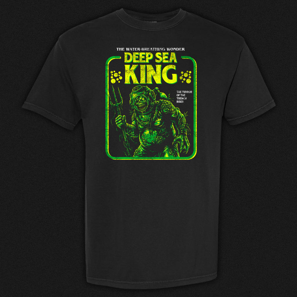 Deep Sea King vintage horror graphic tee featuring a disfigured barnacle-covered figure in an old diving suit in green and yellow on a black Comfort Colors tee.
