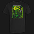 Deep Sea King vintage horror graphic tee featuring a disfigured barnacle-covered figure in an old diving suit in green and yellow on a black Comfort Colors tee.